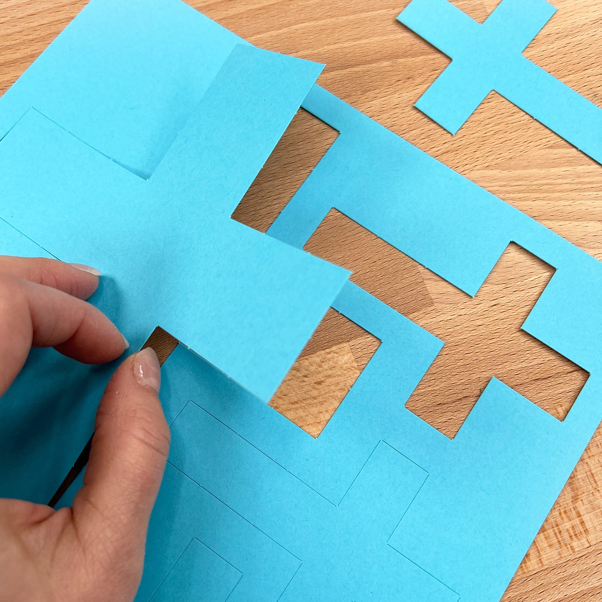 Christian crafts kit with 100 colorful cross cutouts—ideal for crafting religious decorations.