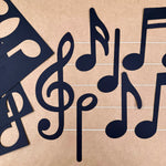 Music notes symbols—black cutouts of music notes and treble clefs, ideal for decorating music sheets and teaching music symbols and meanings.